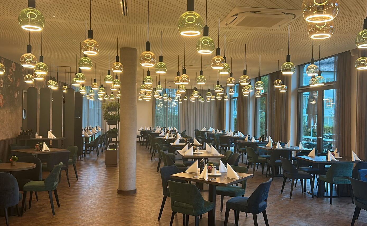 Reference image of the Karlshotel in Sigmaringen, breakfast room featuring a variety of floating light fittings