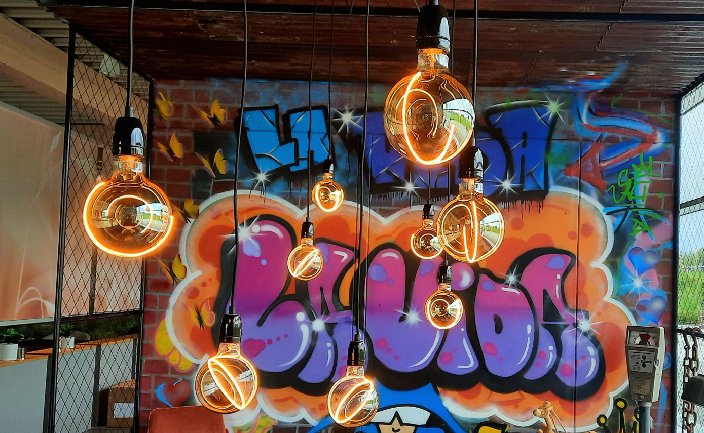 Reference image from Lavida in Oberndorf: wall with graffiti and ‘Illusion’ light fittings in smokey grey