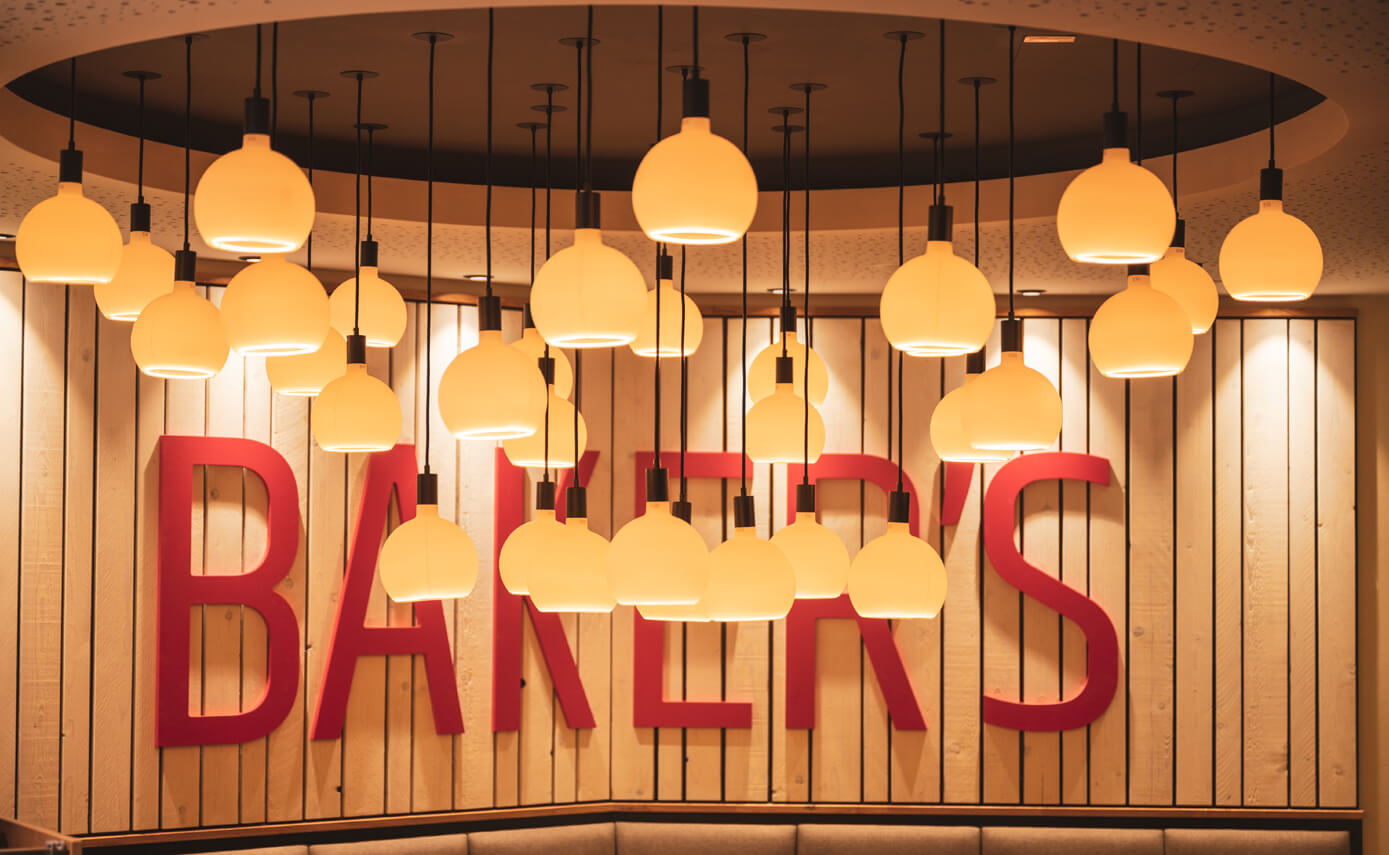 Reference image from lighting designer Maximales Licht: Bakers bakery, featuring numerous matt floating light fittings