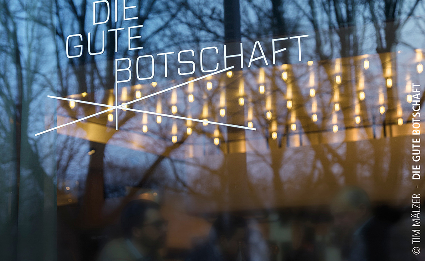 Reference photo of the restaurant ‘Die Gute Botschaft’ in Hamburg, looking in through a window with many light fittings on the ceiling