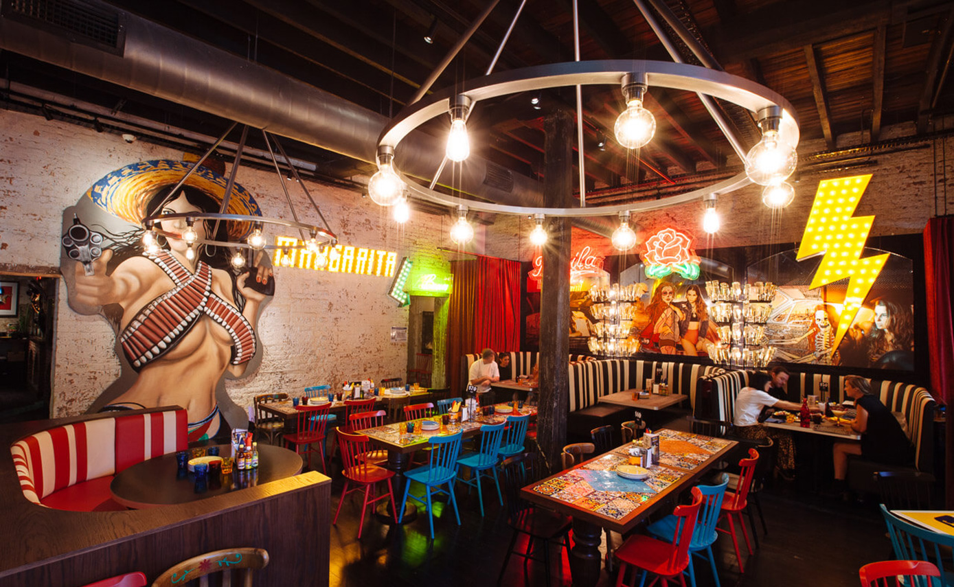Reference image of the El Camino restaurant in Australia, featuring numerous light fittings and chandeliers