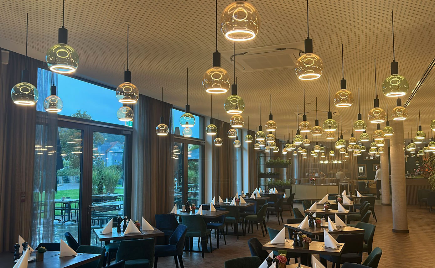 Reference image of the Karlshotel in Sigmaringen, breakfast room featuring a variety of floating light fittings